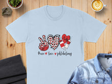 Load image into Gallery viewer, Light blue t-shirt with peace sign, heart, and syringe graphic with "Peace love phlebotomy" text.