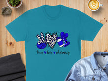 Load image into Gallery viewer, Teal t-shirt with peace, heart, and pharmacy symbols, leopard print.