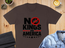 Load image into Gallery viewer, Dark brown t-shirt with "NO KINGS IN AMERICA" text and a crossed-out crown.