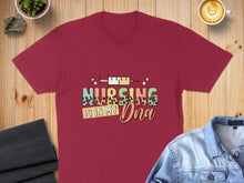 Load image into Gallery viewer, Burgundy t-shirt with "Nursing is in my DNA" text and syringe graphic.