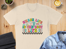 Load image into Gallery viewer, T-shirt with "Nurse Life is the Best Life" text and medical icons.