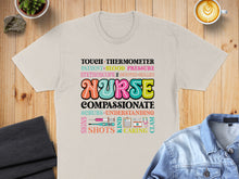 Load image into Gallery viewer, T-shirt with "NURSE" surrounded by medical terms and stethoscope graphic.
