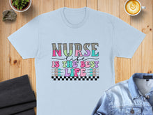 Load image into Gallery viewer, Light blue t-shirt with "Nurse is the best life" graphic and colorful lettering.