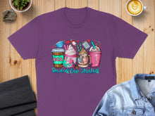 Load image into Gallery viewer, Purple t-shirt with colorful coffee cups and "Resident Care Assistant" text.