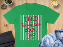 Load image into Gallery viewer, Green t-shirt with "Tired Teacher's Club" in red lettering on pink stripes.
