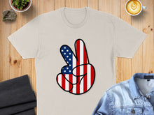 Load image into Gallery viewer, T-shirt with a peace sign made of American flag stripes.
