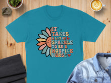 Load image into Gallery viewer, Teal t-shirt with colorful flower graphic and text: "It takes a lot of sparkle to be a hospice nurse".