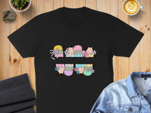 Load image into Gallery viewer, Black t-shirt with colorful pencils, bows, and flowers design across chest.