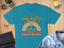 Load image into Gallery viewer, Teal t-shirt with "Just a girl who loves nursing" graphic and rainbow stethoscope.
