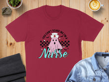 Load image into Gallery viewer, Maroon t-shirt with a ghost wearing a nurse's cap that says "Nurse."