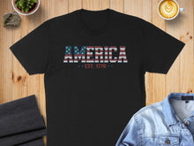 Load image into Gallery viewer, Black t-shirt with "AMERICA EST. 1776" in patriotic red, white, and blue text.