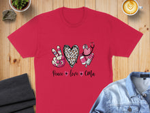Load image into Gallery viewer, Red t-shirt with peace sign, leopard print heart, stethoscope, and syringe graphics.