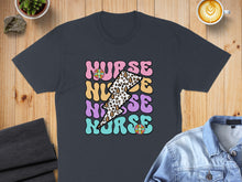 Load image into Gallery viewer, Nurse lightning bolt graphic on dark gray t-shirt, coffee and denim jacket nearby.