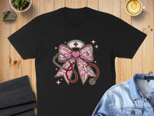 Load image into Gallery viewer, Black t-shirt graphic of a pink stethoscope and nurse cap forming a bow with XOXO hearts.