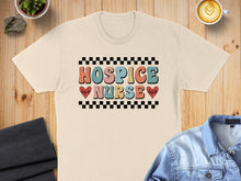 Load image into Gallery viewer, Beige t-shirt with "HOSPICE NURSE" in colorful retro lettering and checkered pattern.