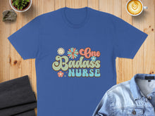 Load image into Gallery viewer, Blue t-shirt with colorful "One Badass Nurse" text and floral graphics.