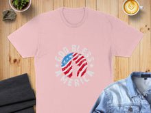 Load image into Gallery viewer, Pink t-shirt with "God Bless America" text and American flag design.
