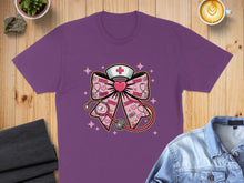 Load image into Gallery viewer, Purple t-shirt with a pink bow featuring a stethoscope, heart, and "XOXO" text.