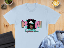 Load image into Gallery viewer, Light blue t-shirt with "Registered Nurse" text and a woman with butterflies.