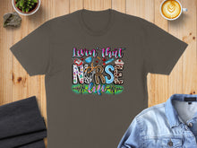 Load image into Gallery viewer, T-shirt with "Lovin' that Nurse Life" text and medical symbols.