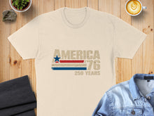 Load image into Gallery viewer, Cream t-shirt with "AMERICA 76 250 YEARS" text and distressed flag graphic.