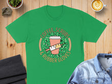 Load image into Gallery viewer, Green t-shirt with "Coffee, Scrubs & Rubber Gloves" text and medical graphic.