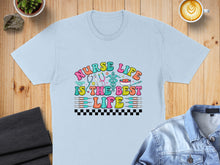 Load image into Gallery viewer, Light blue t-shirt with "Nurse Life is the Best Life" text and medical symbols.