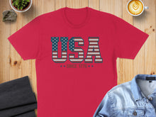 Load image into Gallery viewer, Red t-shirt with "USA" in patriotic stars and stripes pattern.