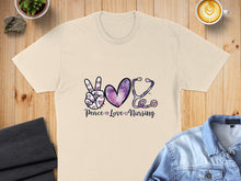 Load image into Gallery viewer, Cream t-shirt with "Peace Love Nursing" and a stethoscope-heart design.