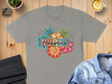 Load image into Gallery viewer, Grey t-shirt with "Nurse" text surrounded by colorful flowers and leaves.