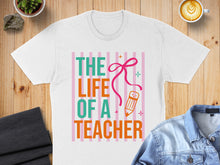 Load image into Gallery viewer, White t-shirt with "THE LIFE OF A TEACHER" text and pencil graphic.