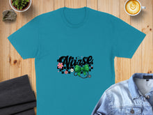 Load image into Gallery viewer, Teal t-shirt with "Nurse" text, stethoscope, flowers, and checkered pattern.