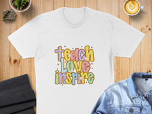 Load image into Gallery viewer, White t-shirt with "Teach Love Inspire" text in colorful, bubbly font.
