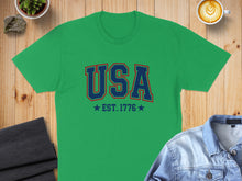 Load image into Gallery viewer, Green t-shirt with "USA EST. 1776" text in blue and red.