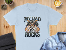 Load image into Gallery viewer, Light blue t-shirt with "MY DAD ROCKS" and crossed guitars graphic.