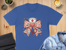 Load image into Gallery viewer, Blue t-shirt with a pink stethoscope and cross on a bow, adorned with XOXO hearts.