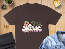 Load image into Gallery viewer, Brown t-shirt with "Blessed Nurse" text and pastel rainbow accents.