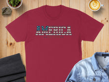 Load image into Gallery viewer, Maroon t-shirt with "AMERICA" in striped text and stars.