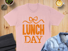 Load image into Gallery viewer, Pink t-shirt with "LUNCH DAY" graphic and bow detail.
