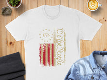 Load image into Gallery viewer, White t-shirt with distressed American flag graphic and "We The People" text.