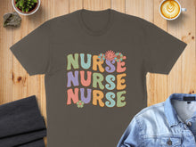 Load image into Gallery viewer, Brown t-shirt with "NURSE NURSE NURSE" text and floral details.