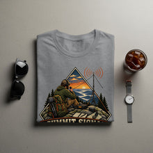 Load image into Gallery viewer, Grey t-shirt with graphic of man with radio and antenna on a mountain at sunset.