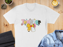 Load image into Gallery viewer, White t-shirt with "Teacher" graphic featuring school supplies and flowers.