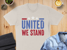 Load image into Gallery viewer, Beige t-shirt with "UNITED WE STAND" text and three white stars.
