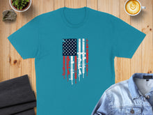 Load image into Gallery viewer, Teal t-shirt with distressed American flag graphic featuring firearms.