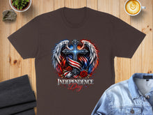 Load image into Gallery viewer, Dark brown t-shirt with patriotic cross, wings, roses, and "Independence Day" text.
