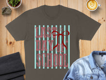 Load image into Gallery viewer, Brown t-shirt with "Last Day of School" text and a red bow.

