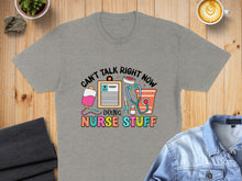 Load image into Gallery viewer, Gray t-shirt with colorful text: "Can't talk right now, doing nurse stuff."
