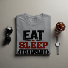 Load image into Gallery viewer, Grey t-shirt with "EAT SLEEP TRANSMIT" text and graphic design.
