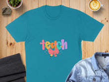 Load image into Gallery viewer, Teal t-shirt with "teach" in colorful, playful lettering and a pink bow.

